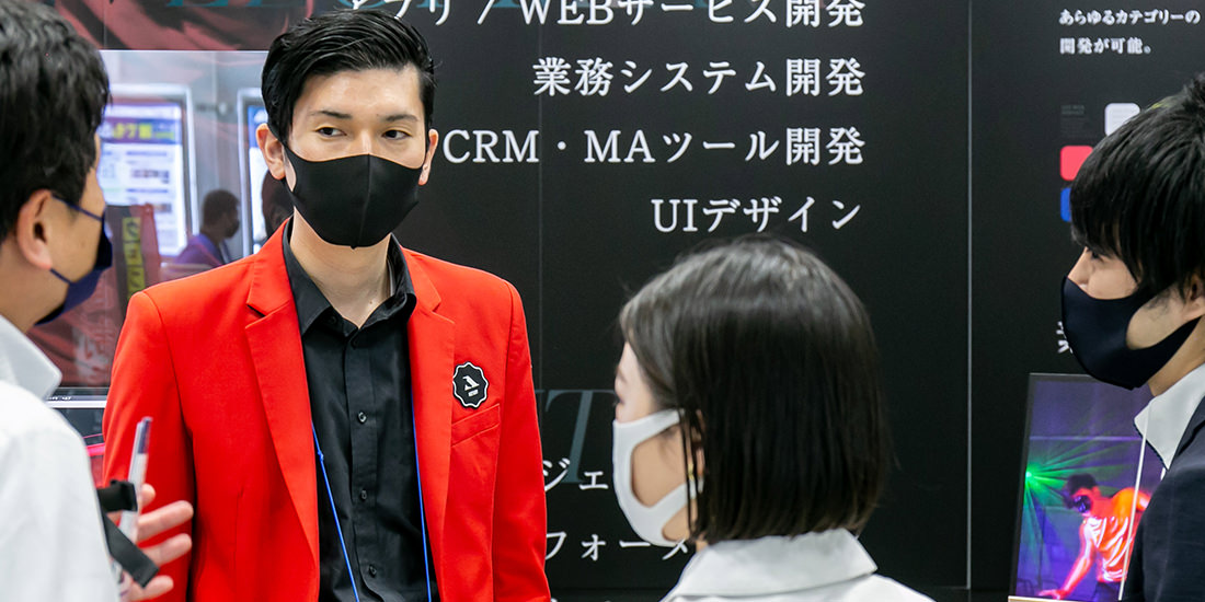 アプリ開発について来場者から質問に答えるスタッフ